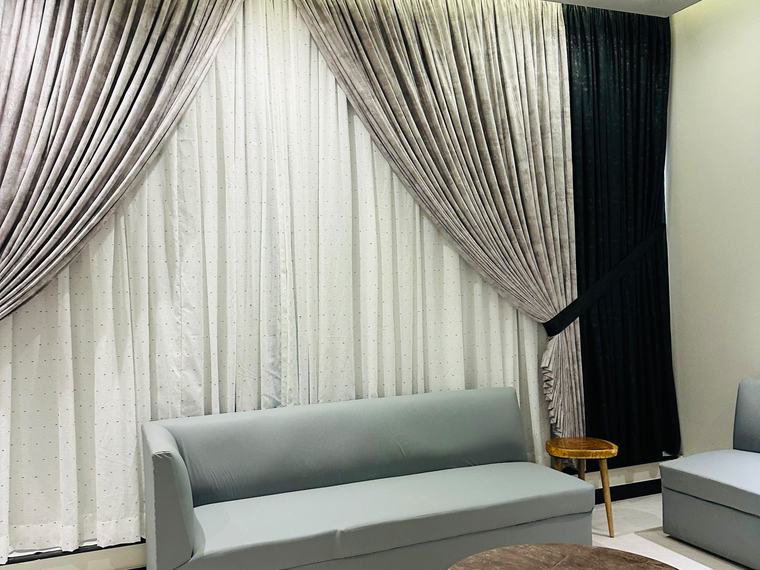Living room lounge with draped curtains